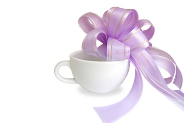 Fototapeta na wymiar White cup with purple bow