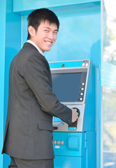 business man using Automatic Telling Machine