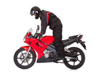 Obraz na płótnie Canvas Biker na stojąco podczas jazdy jego motocykl