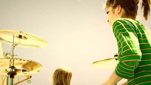 Alternative music band performing outdoors. Old movie.