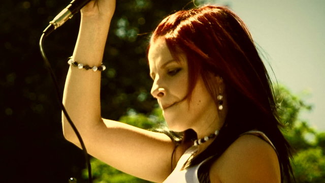 Lead singer of a punk band during a concert. Old movie.