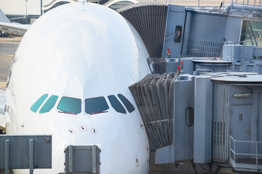 Jetway Bridges And Airplane Waiting Boarding