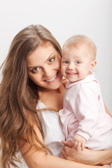 young mother  holding her baby girl on hands