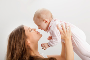 young mother  holding her baby girl on hands