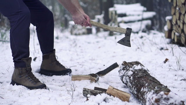 Lumberjack chopping wood in the winter, super slow motion