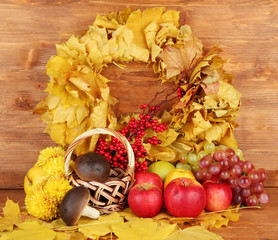 Autumnal composition with yellow leaves, apples and mushrooms