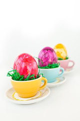 Easter eggs in colorful cups