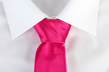 New white man's shirt with color tie on wooden background