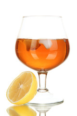 Glass of brandy with ice and lemon isolated on white