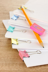 Documents with binder clips on wooden table