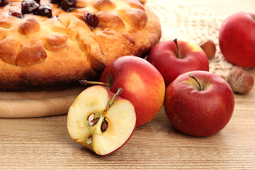 tasty homemade pie with jam and apples, on wooden table
