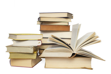 stacks of books, one opened, isolated on white background