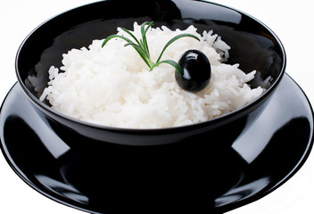 White rice in black bowl isolated