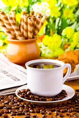 Coffee cup with fresh coffe beans for breakfast