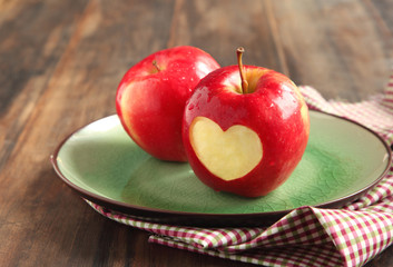 Red apple with a heart shaped cut-out