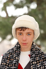 Handsome teen boy in white fur hat