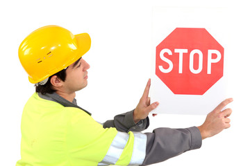 Laborer showing stop sign