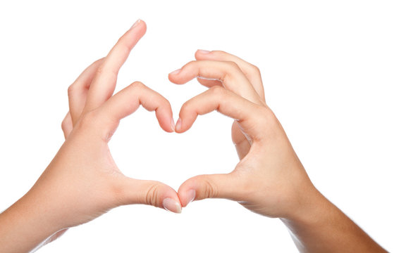 Two teenager hands form a heart shape with their fingers. on whi