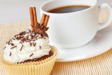 chocolate cake with whipped cream, decorated anise and cinnamon