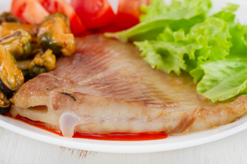 fried fish with mussels and fresh salad