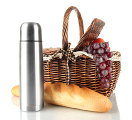 Picnic basket with fruits,bread and thermos isolated on white