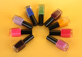 bright nail polishes on yellow background