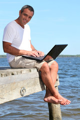 man with a laptop on holidays