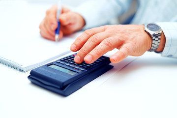 Closeup of a businessman calculating