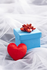 Blue Gift box with red bow on wedding veil