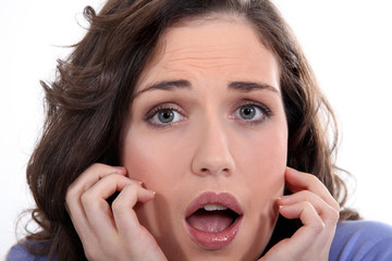 Close-up of a young woman with expression of fear