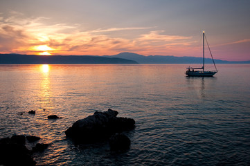 Sunset on the sea at Glavotok with sailing boat - Krk - Croatia