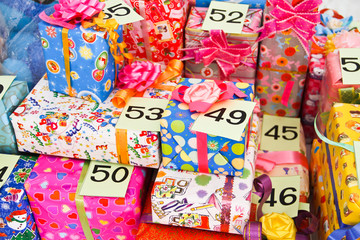 pile of Christmas gifts in colorful wrapping with ribbons agains