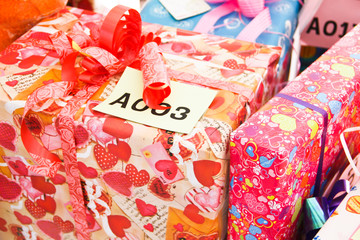 Fototapeta na wymiar pile of Christmas gifts in colorful wrapping with ribbons agains