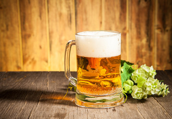 Glass of beer on wooden table
