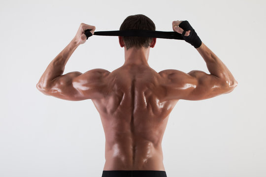 The muscular male back on white background