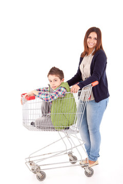 Happy mother with her kid sitting in shopping basket