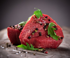 Raw beef steaks on wooden table