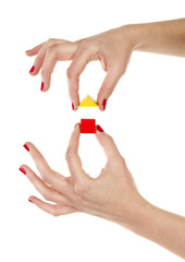 Hands are assembling wooden house