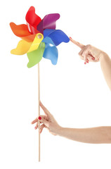 Hand are holding and moving colorful pinwheel toy