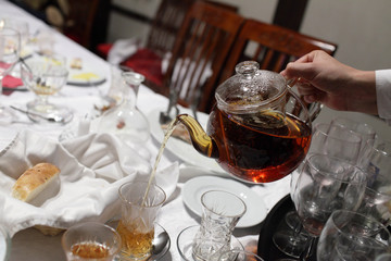Waiter pouring tea