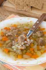 soup with beef and buckwheat groats in a plate closeup vertical