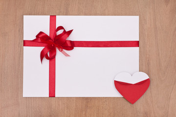 valentine card with red ribbon and red heart