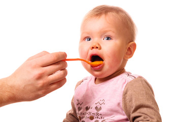 man is feeding his baby