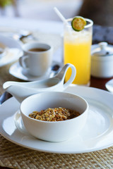 Delicious breakfast with cereals, milk, fruit juice and coffee
