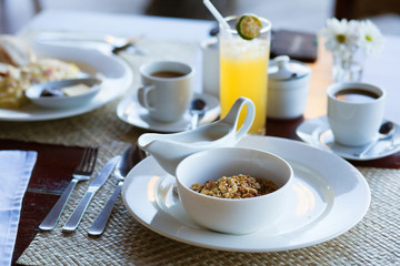 Delicious breakfast with cereals, milk, fruit juice and coffee
