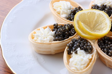 Canape with cream cheese and caviar. selective focus