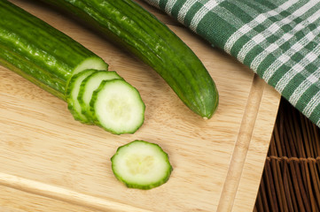 Sliced ​​cucumber on a wooden board