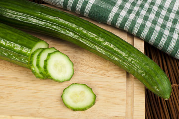 Sliced ​​cucumber on a wooden board