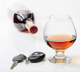 glass of alcohol and car keys