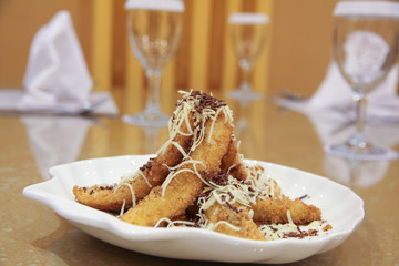 fried banana with cheese on table